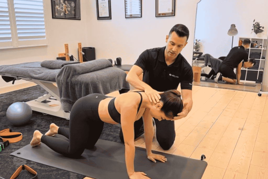 Physiotherapist demonstrating chin tuck exercise for neck pain relief and better posture in Preston